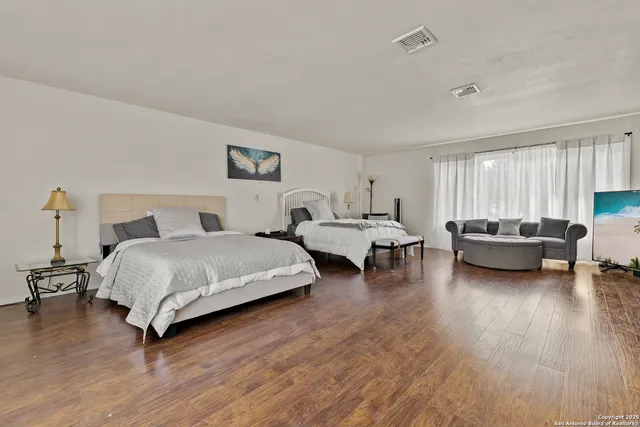 a spacious bedroom with a bed and a couch