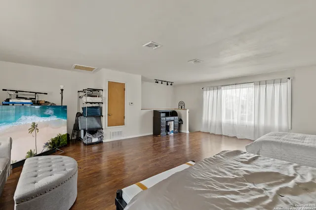 a bedroom with furniture and a wooden floor