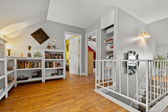 a living room with lots of furniture and baby book shelf