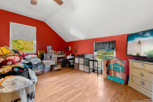 a living room with lots of furniture and clutter