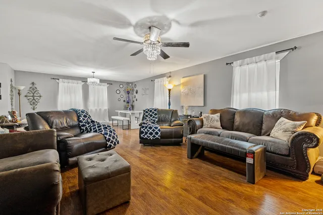 a living room with furniture and a chandelier