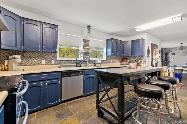 a kitchen with a sink and wooden cabinets