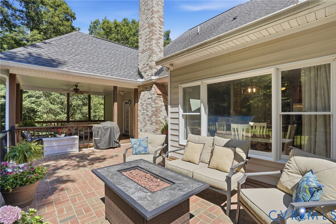 12123 Deer Ridge Court Ashland, VA 23005 - Photo 54 of 63 a view of a patio with couches table and chairs and potted plants