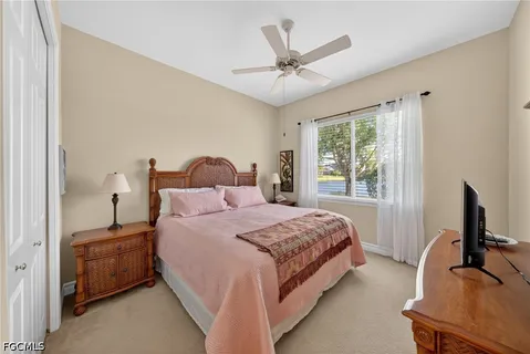 a bathroom with a granite countertop sink a toilet a mirror and shower