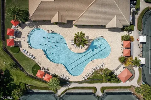 an aerial view of a house with a yard