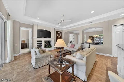 a living room with furniture a couch and a chandelier