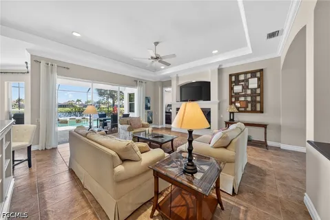 a living room with furniture a window and gym equipment