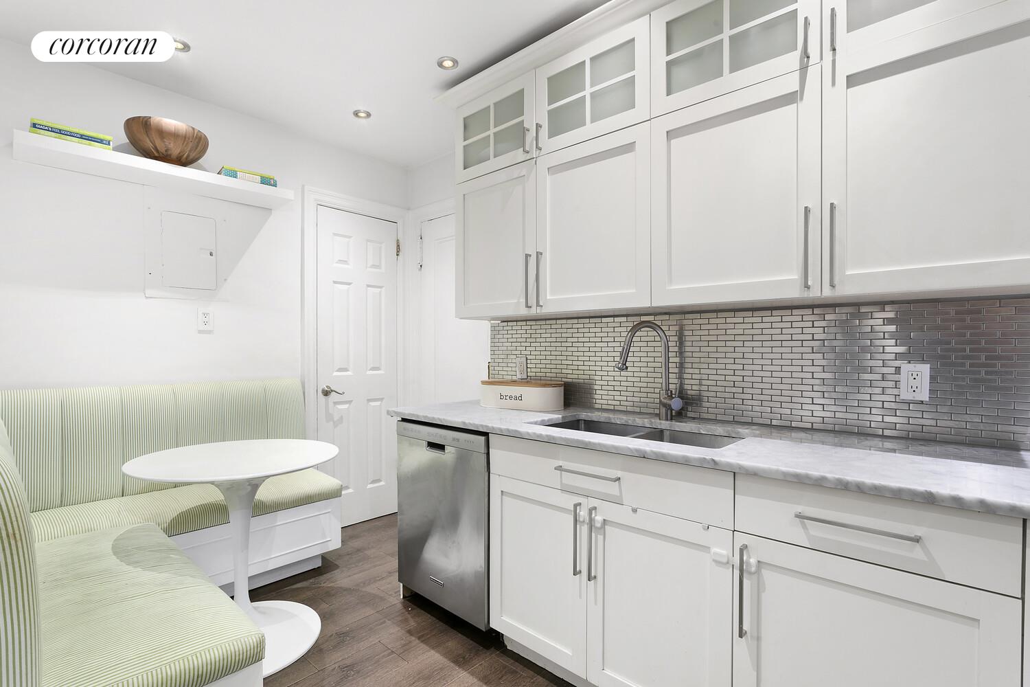 65 East 96th Street, Unit 7D Manhattan, NY 10128 - Photo 6 of 12 a kitchen with a sink cabinets and wooden floor