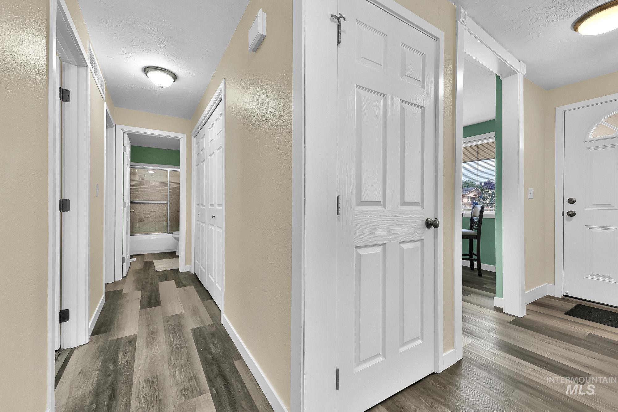 5755 Chuckwagon Road Nampa, ID 83686 - Photo 19 of 50 Wood-finish flooring throughout, white trim, and white paneled doors