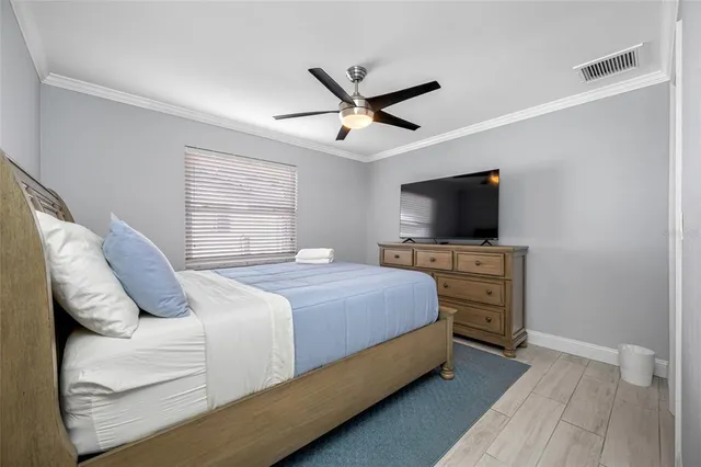 a living room with hard wood floors and a ceiling fan