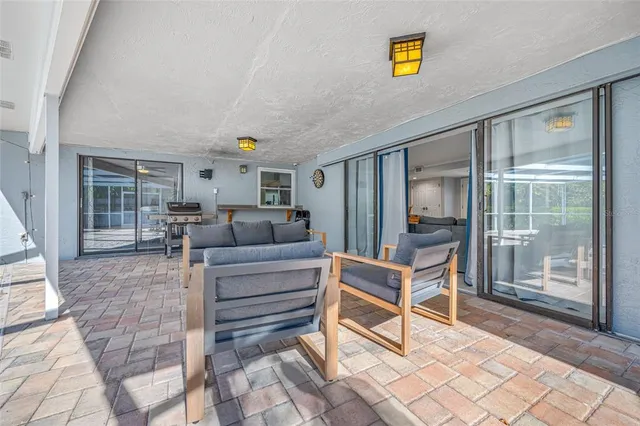 an aerial view of residential houses with outdoor space and trees