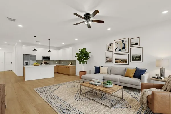 a living room with furniture kitchen view and a table
