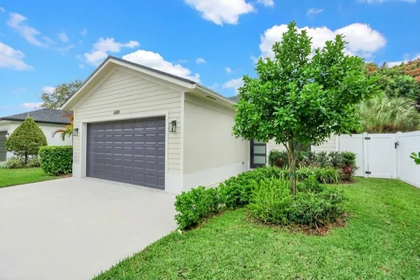 a front view of house with yard and trees