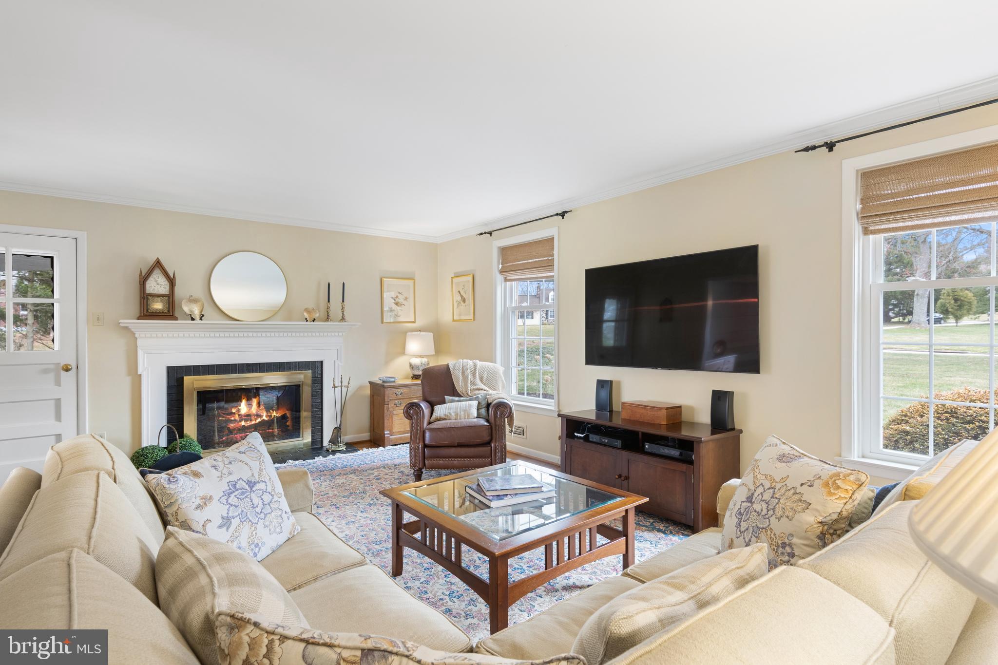 653 Baron Dekalb Road Wayne, PA 19087 - Photo 14 of 32 a living room with furniture a fireplace and a flat screen tv