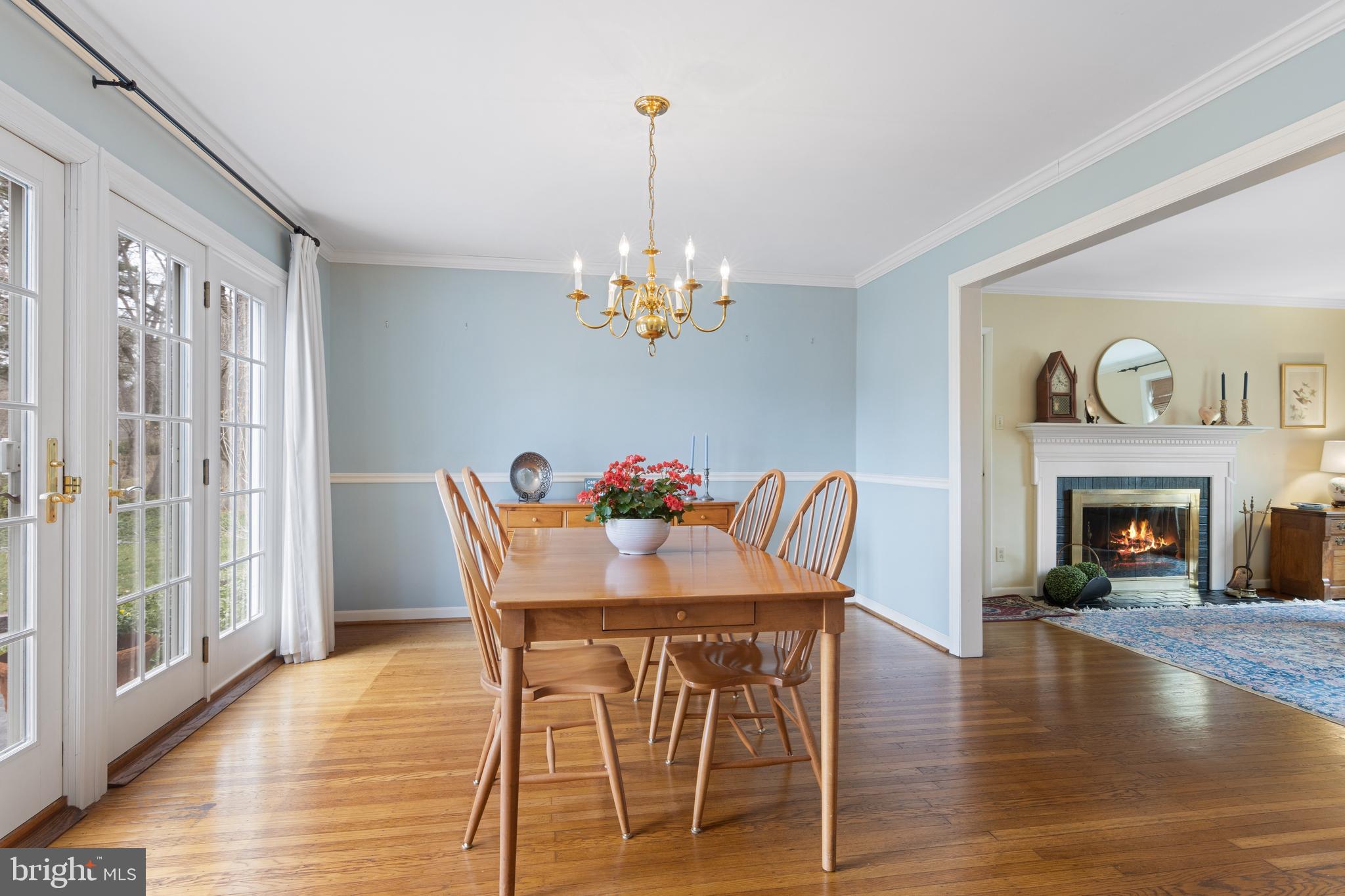 653 Baron Dekalb Road Wayne, PA 19087 - Photo 19 of 32 a dining room with furniture wooden floor a fireplace and a chandelier