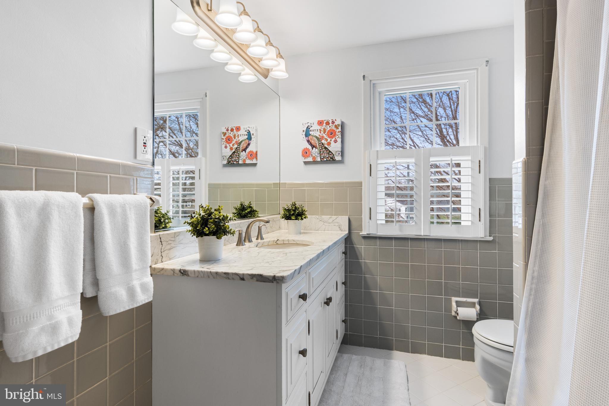 653 Baron Dekalb Road Wayne, PA 19087 - Photo 25 of 32 a bathroom with a sink a toilet and a shower curtain