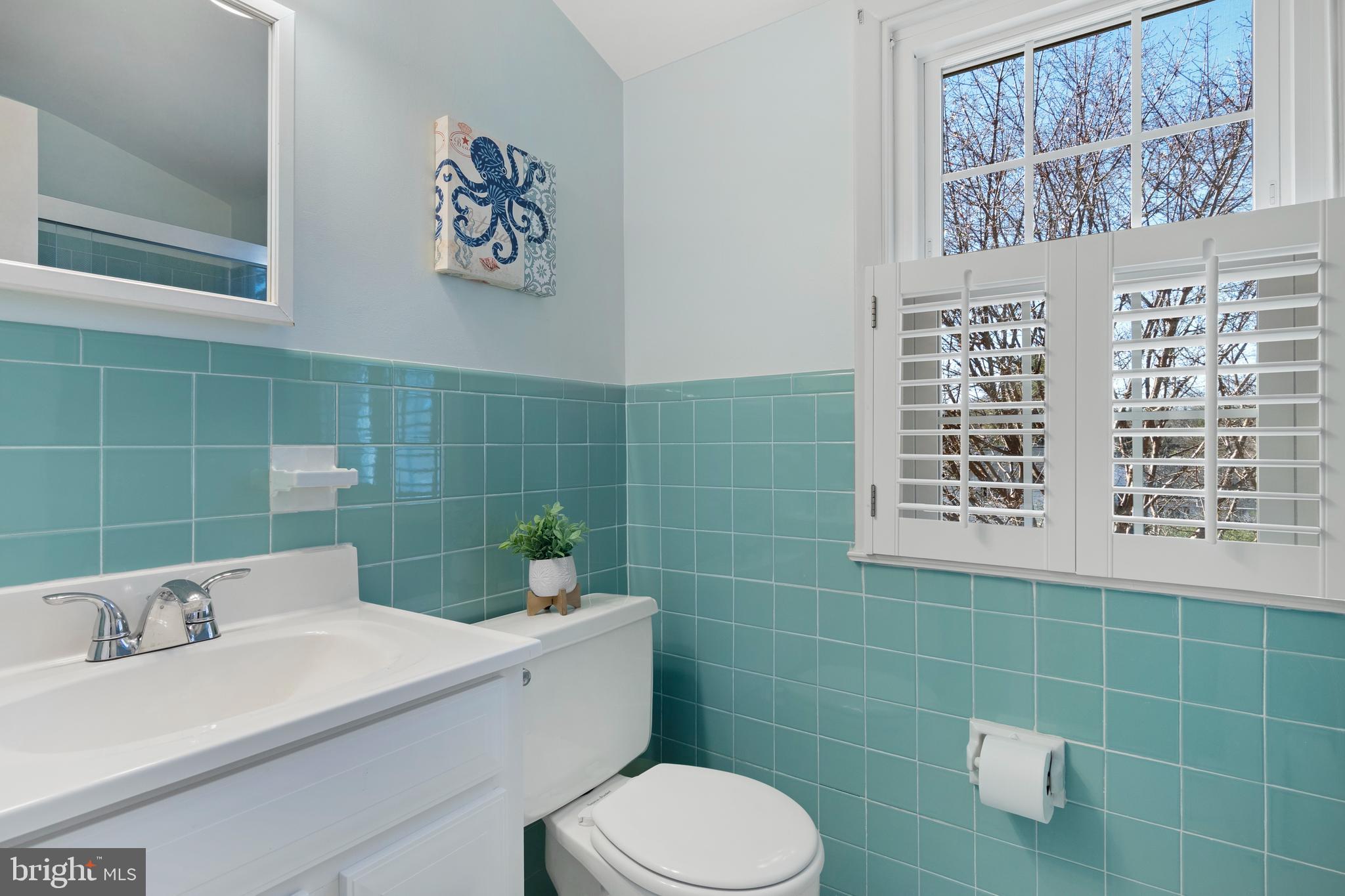 653 Baron Dekalb Road Wayne, PA 19087 - Photo 28 of 32 a bathroom with a sink a toilet and a mirror