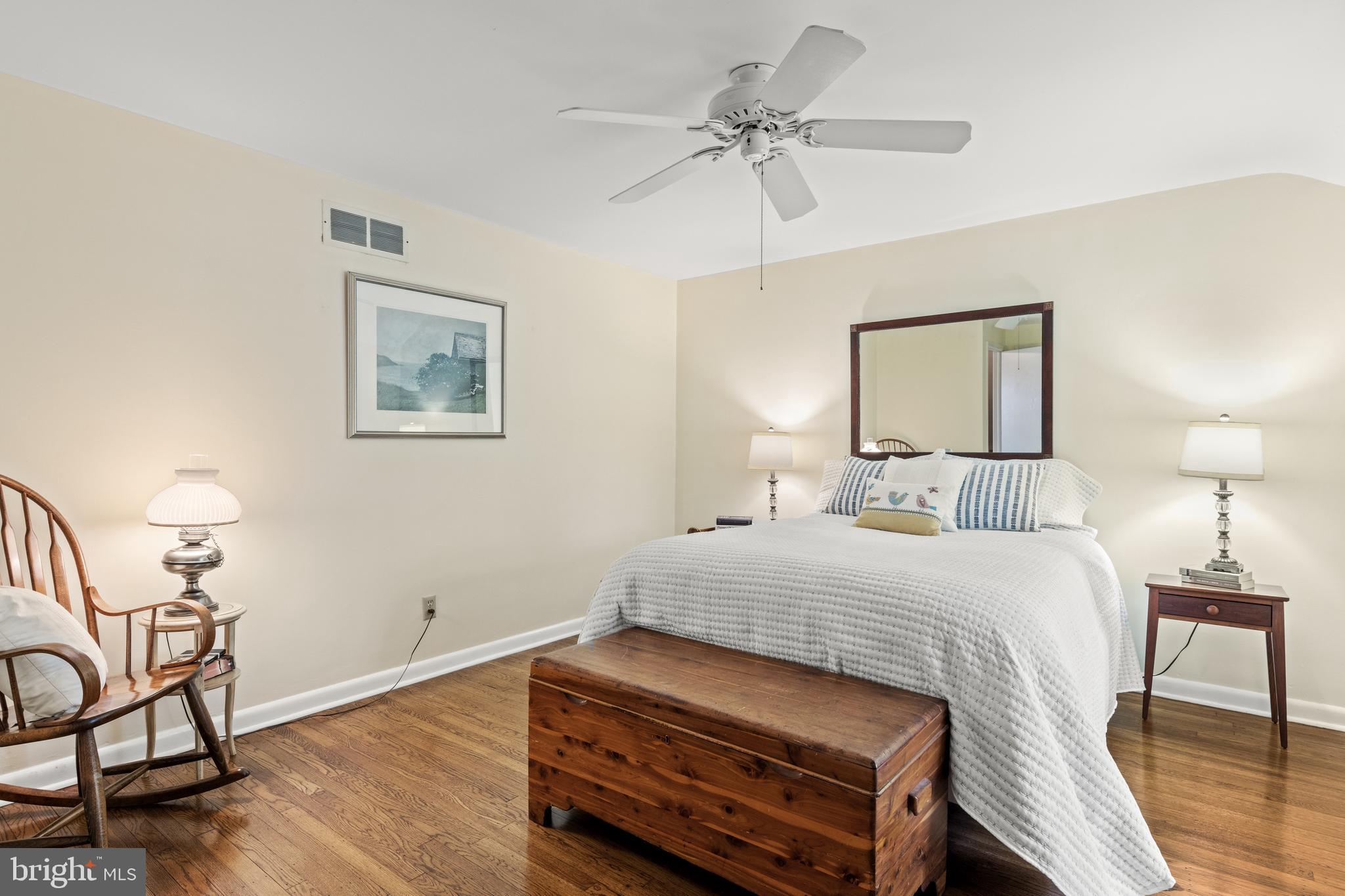 653 Baron Dekalb Road Wayne, PA 19087 - Photo 29 of 32 a bedroom with a bed a chandelier and painting on the wall