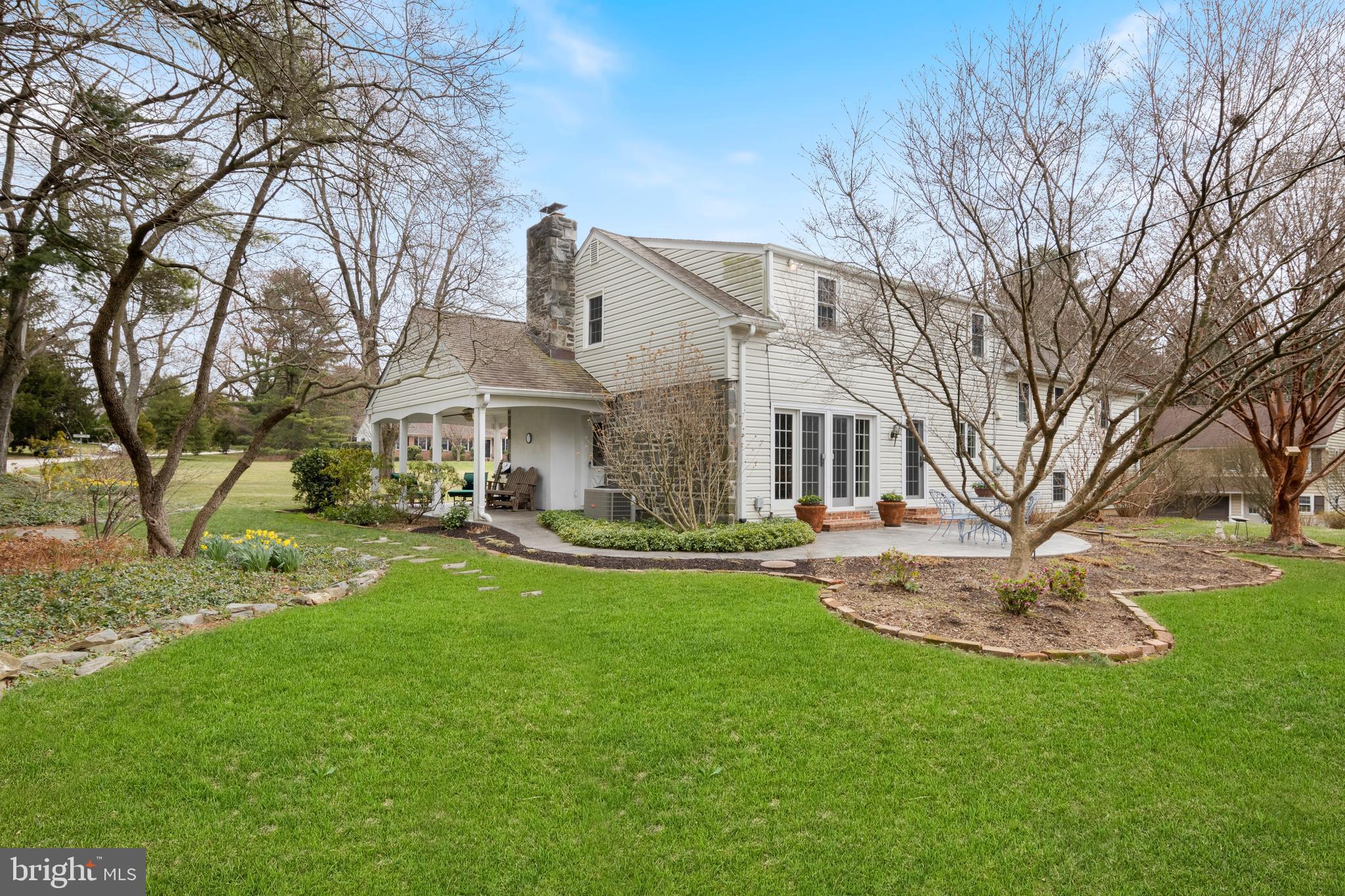 653 Baron Dekalb Road Wayne, PA 19087 - Photo 5 of 32 a front view of a house with a garden and trees