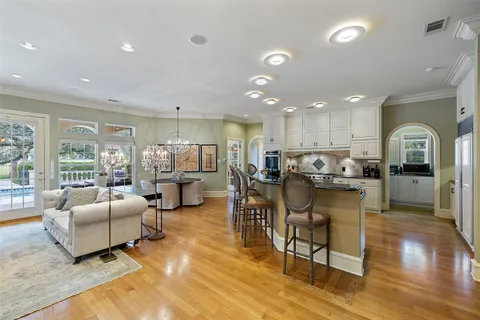 a living room with lots of furniture and kitchen view