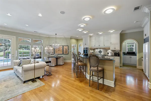 a living room with lots of furniture and kitchen view