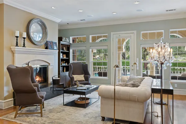a living room with furniture a fireplace and a large window