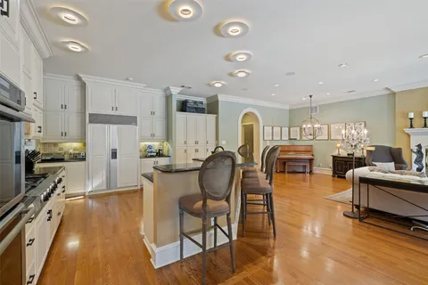 a large kitchen with lots of counter space and furniture