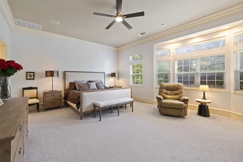 a bedroom with furniture and a large window