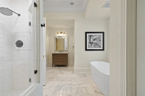 a bathroom with a tub shower and mirror
