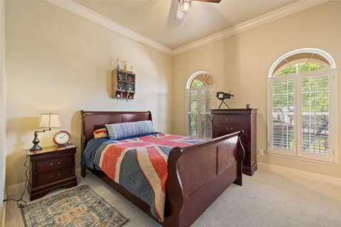 a bedroom with a bed and a chandelier