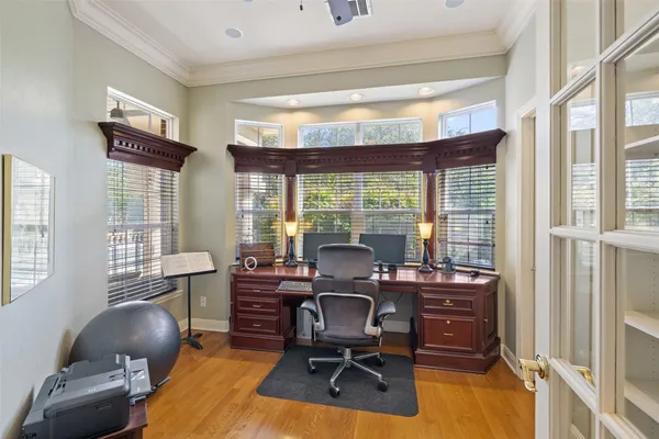 a workspace with furniture and a large window