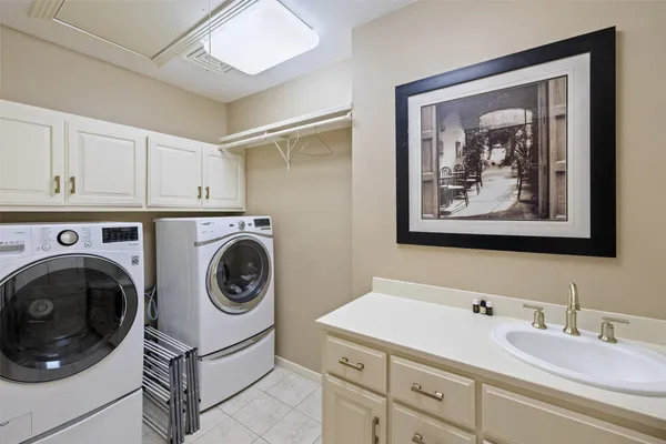 a bathroom with a sink a washer and dryer