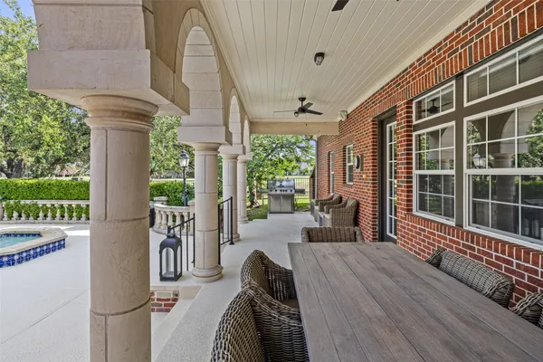 a balcony view with a large window and wooden floor