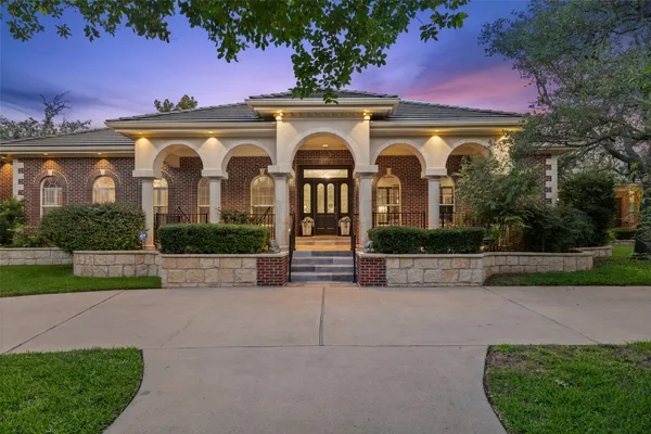 a front view of a house with yard and green space
