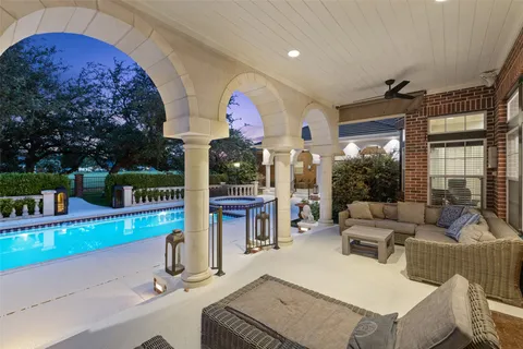 a living room with couches a large dining table and chairs with outer view