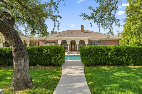a front view of a house with a garden