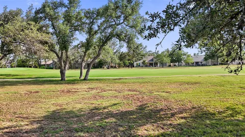 a view of a field with trees in the background