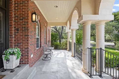 a view of a patio with table and chairs and potted plants