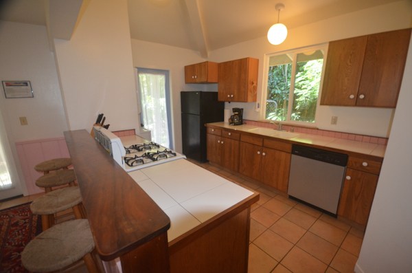 2231 Pane Road Koloa, HI 96756 - Photo 22 of 25 a kitchen with a table chairs and a refrigerator