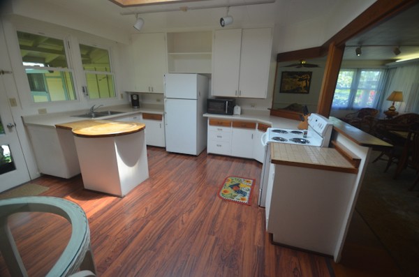 2231 Pane Road Koloa, HI 96756 - Photo 6 of 25 a kitchen with sink a refrigerator and wooden floor