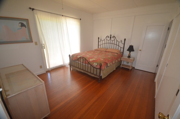 2231 Pane Road Koloa, HI 96756 - Photo 7 of 25 a bedroom with a bed and wooden floor