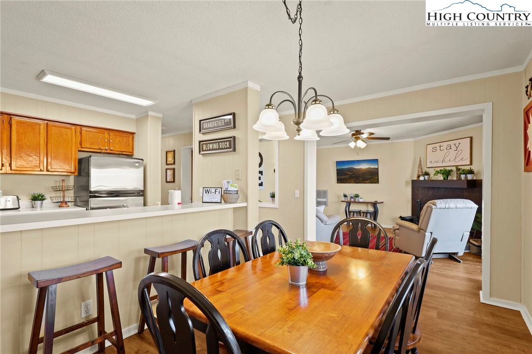301 Pinnacle Inn Road, Unit 3305 Beech Mountain, NC 28604 - Photo 15 of 29 a view of a dining room with furniture window and wooden floor