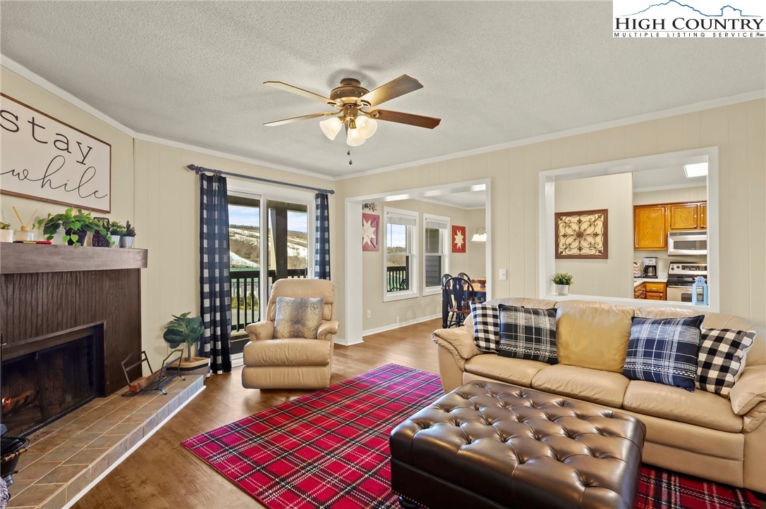 301 Pinnacle Inn Road, Unit 3305 Beech Mountain, NC 28604 - Photo 2 of 29 a bedroom with furniture and a fireplace