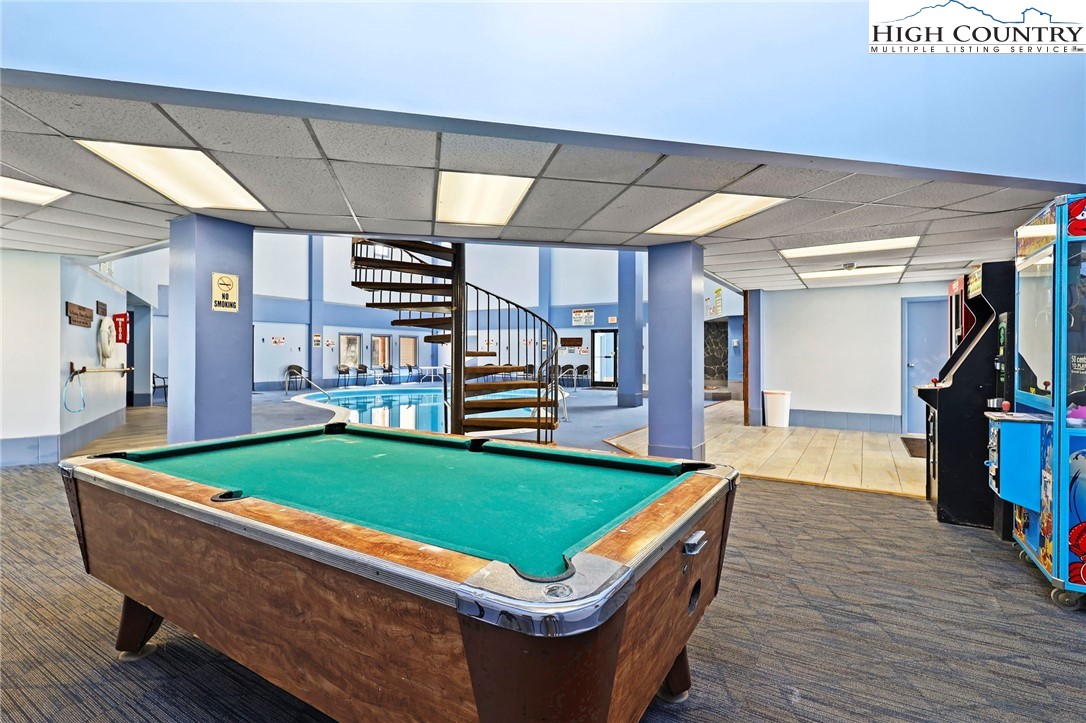 301 Pinnacle Inn Road, Unit 3305 Beech Mountain, NC 28604 - Photo 24 of 29 a room with pool table windows and wooden floor