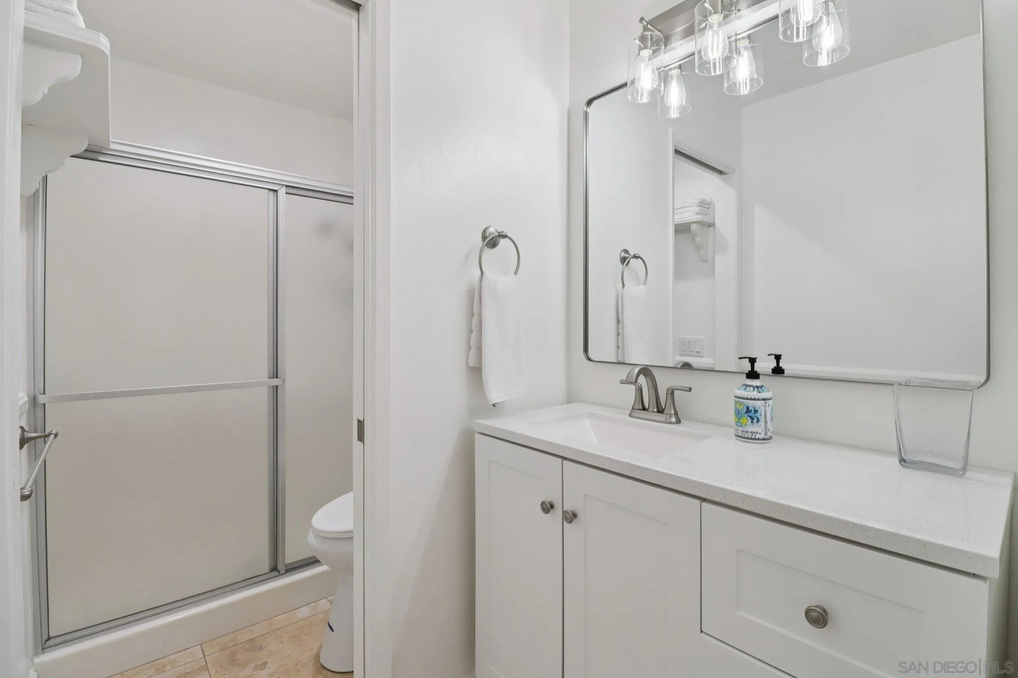816 Caminito Azul Carlsbad, CA 92011 - Photo 17 of 41 a bathroom with a sink and a mirror