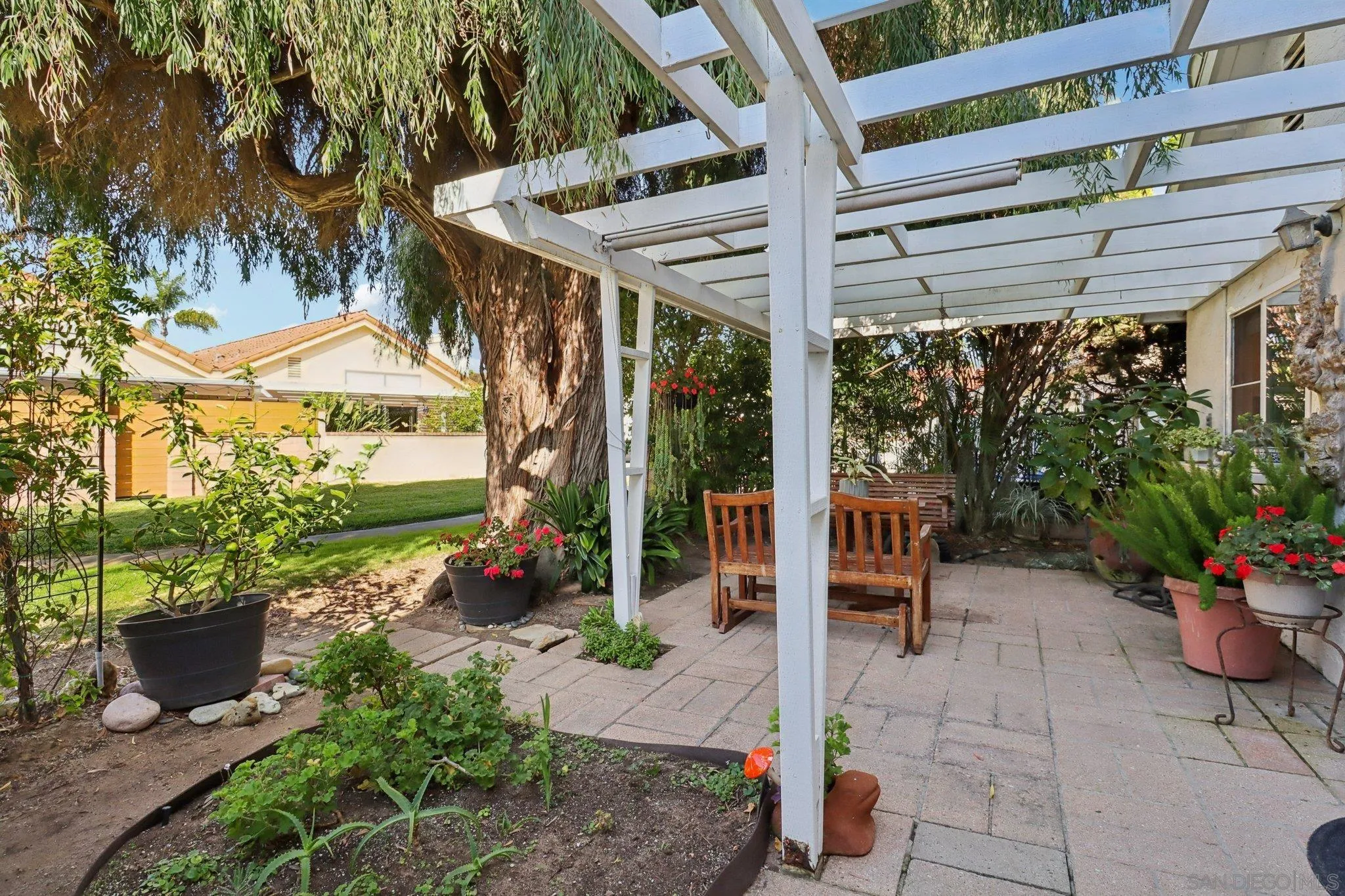 816 Caminito Azul Carlsbad, CA 92011 - Photo 4 of 41 a view of a patio with table and chairs potted plants and floor to ceiling window and potted plants