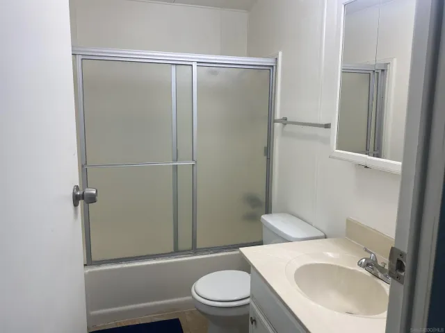 a white toilet sitting next to a bathroom sink