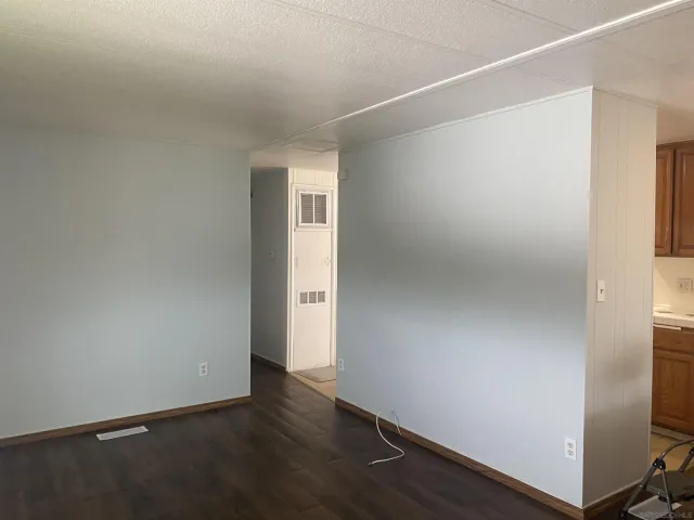 an empty room with wooden floor