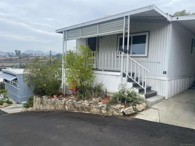 a view of a house with a small yard and plants