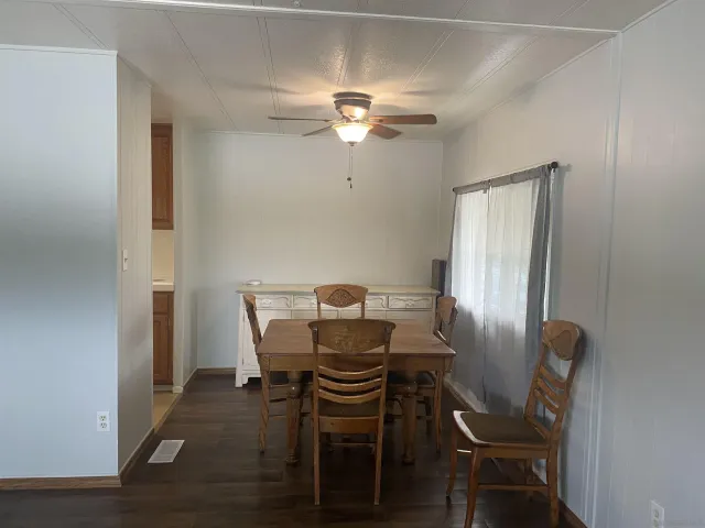 a view of a dining room with furniture and chandelier